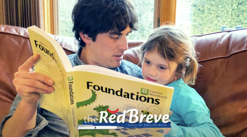 Hayden Kvamme looking at the Foundations B workbook with his daughter